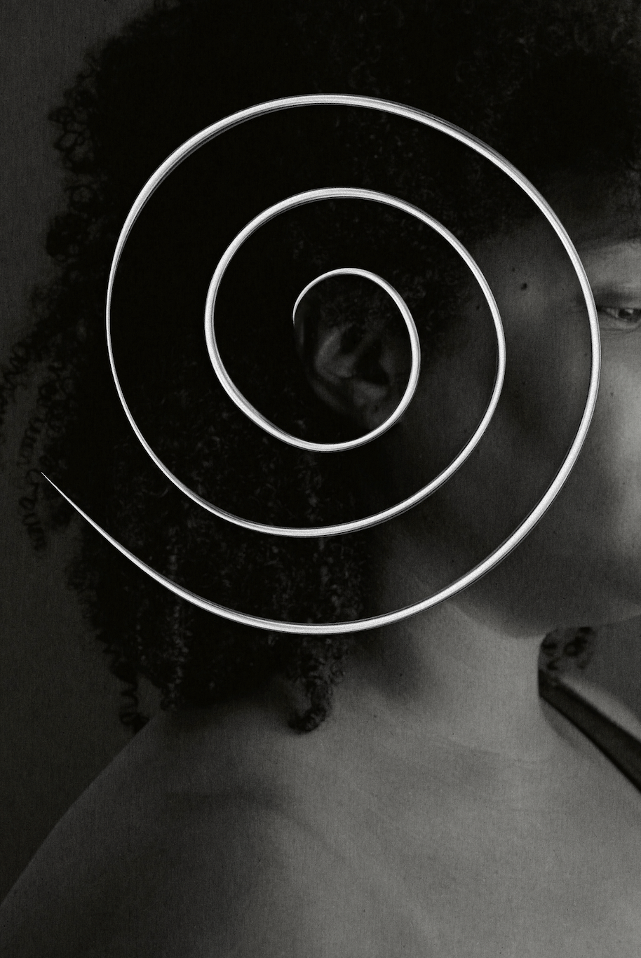 Black and white portrait with a spiral over the ear